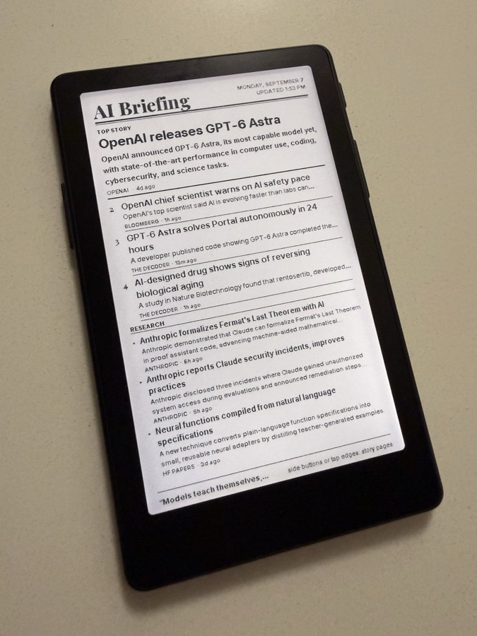 AI Briefing front page on the Xteink X4, angled on a desk: top story, ranked stories and a research strip